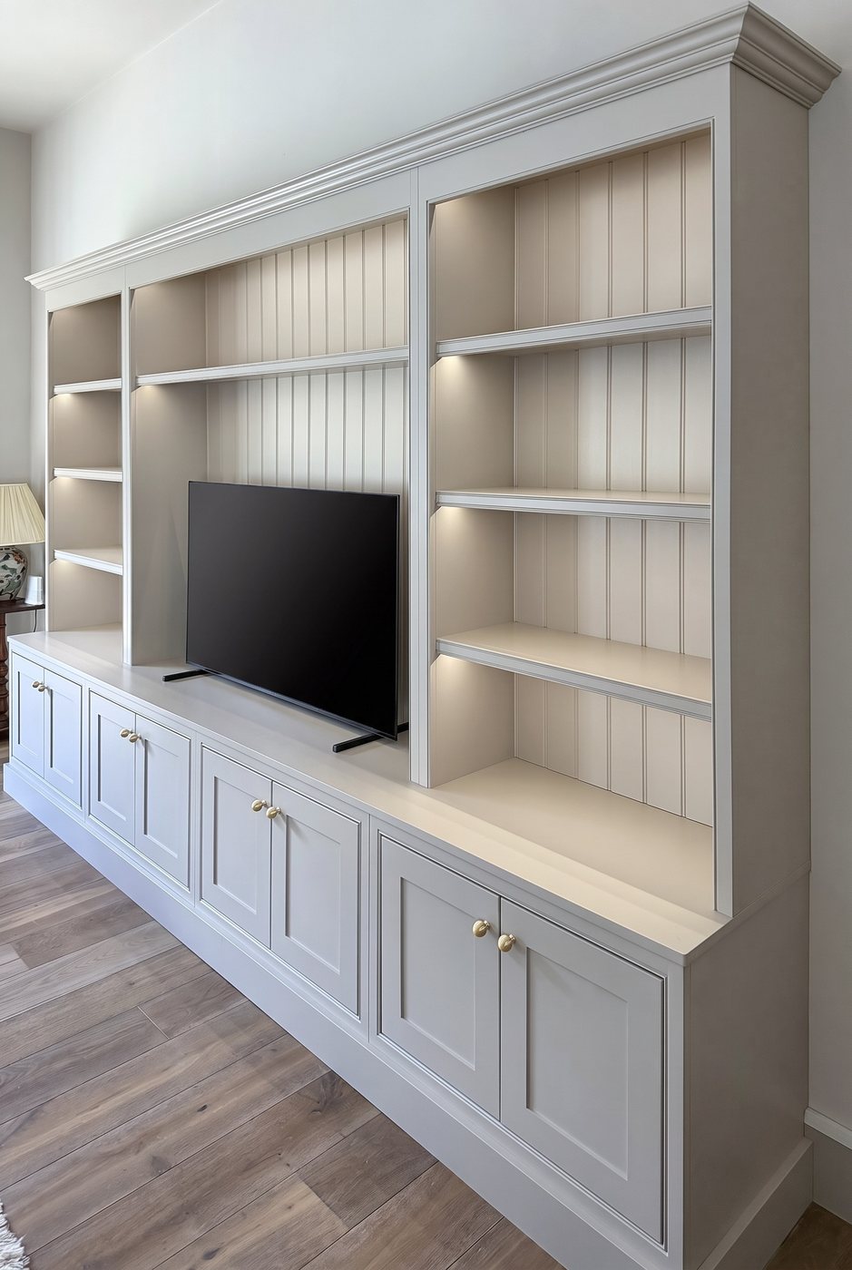Painted bookcase and media unit with lit shelves