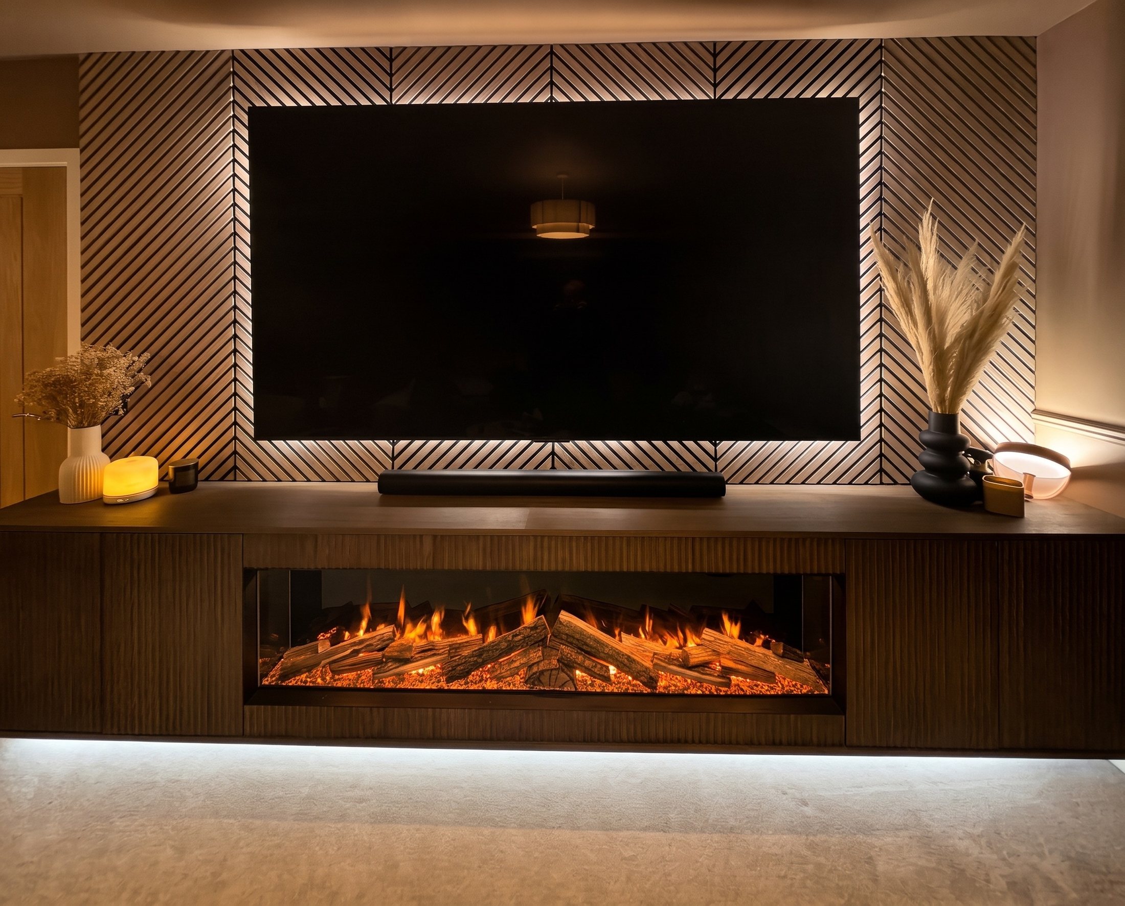 Dark fluted media unit with an inset fire below a TV on slatted wall panelling