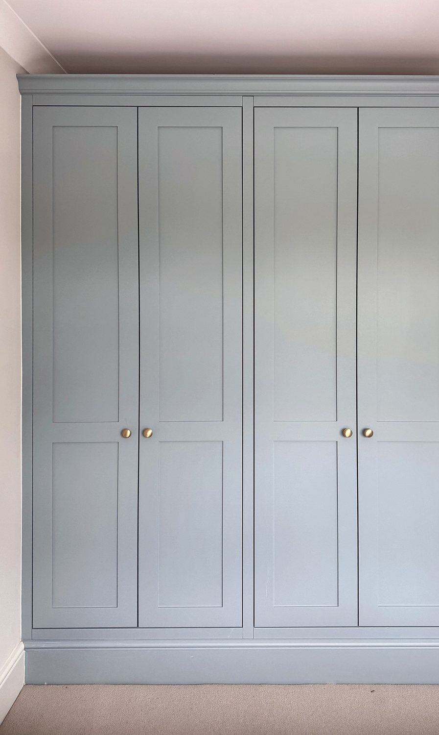 Pale blue fitted wardrobe with four panelled doors