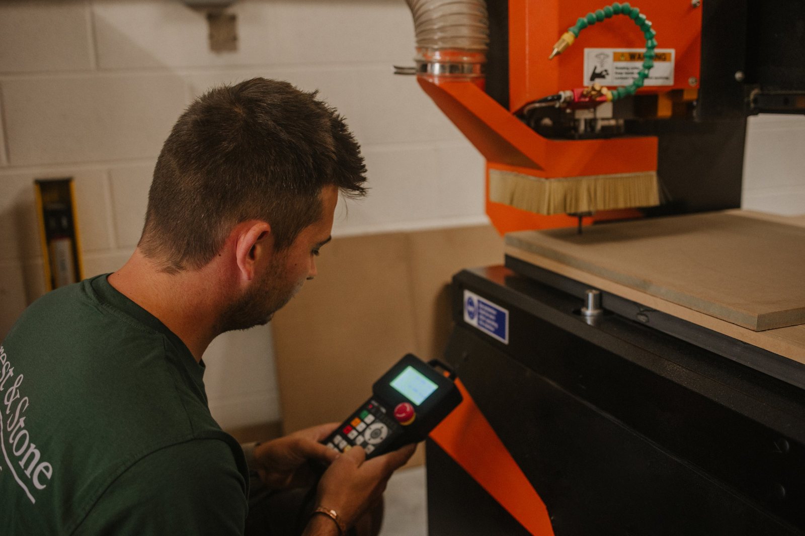 Setting up the CNC router with its handheld controller in the Forest & Stone workshop