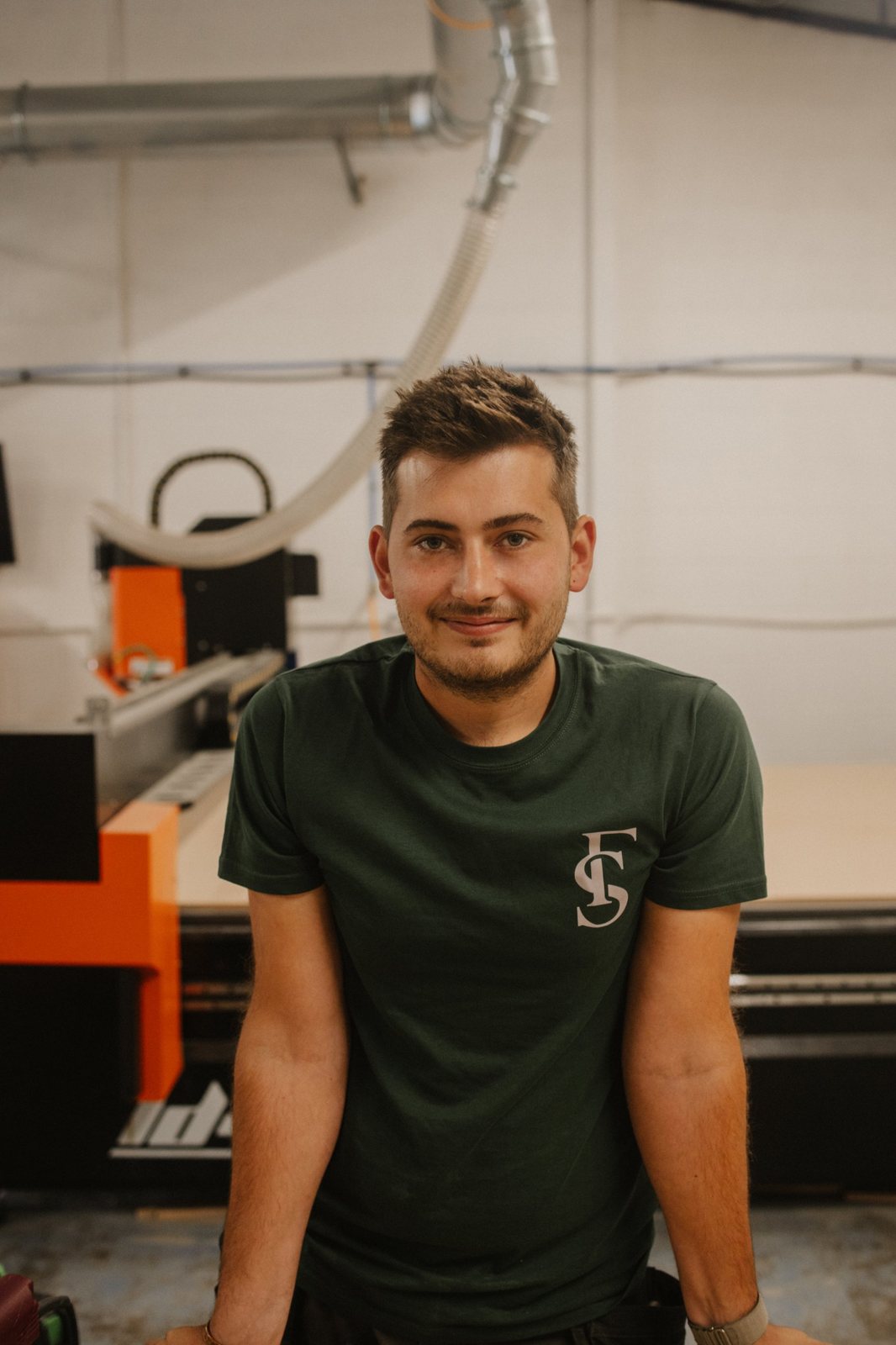 Andrew in the Forest & Stone workshop, in front of the CNC router